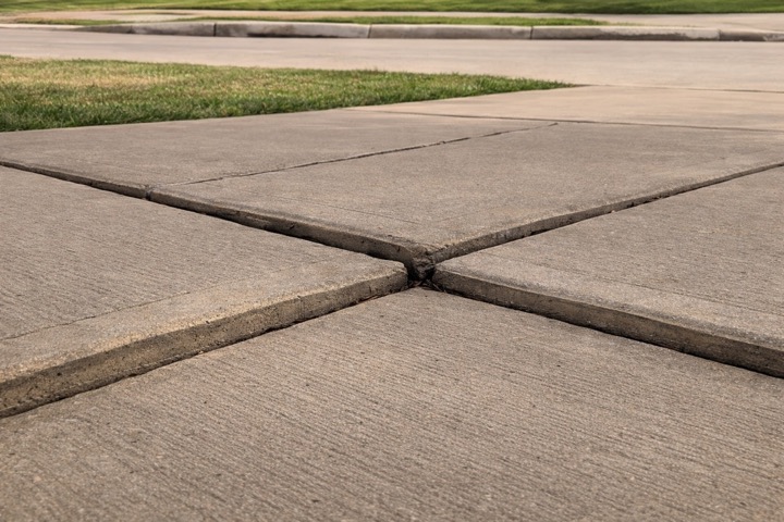 Sunken driveway panel before Flatworks concrete leveling