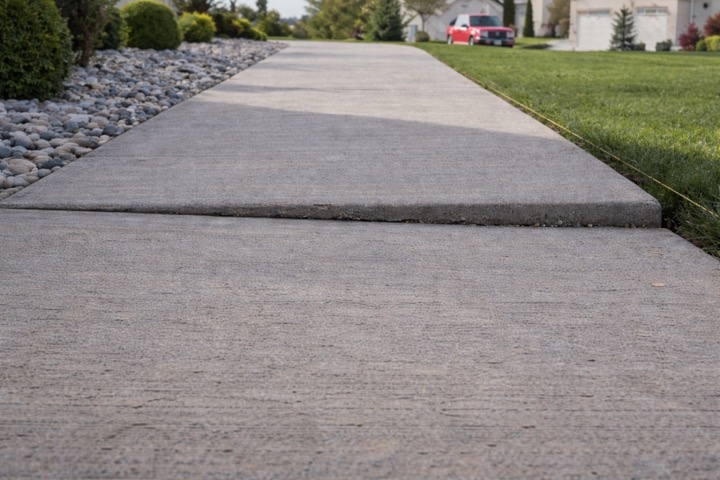 Uneven sidewalk before Flatworks concrete leveling